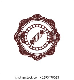 Red candy icon inside rubber grunge seal