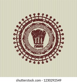 Red chef hat icon inside distressed rubber seal