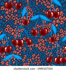 Red cherries seamless background. Ripe berries at colorful spotted leopard texture. Flat design. Intricate pattern made of animal skin and botanical ornament for fabric, textile, dress, wrapping.