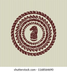 Red chess knight icon inside rubber seal