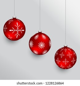 Red christmas balls with snowflake pattern and silver hangers. Set of holiday ornaments.