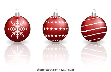 Red christmas baubles on white background with reflection.