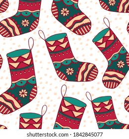 Red Christmas stocking vector seamless pattern. Festive decorative illustration with doodle hand drawn sock in calm winter palette for wrapping paper, wallpaper, textile