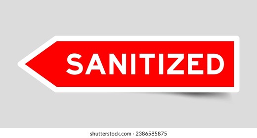 Red color arrow shape sticker label with word sanitized on gray background