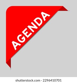 Red color of corner label banner with word agenda on gray background