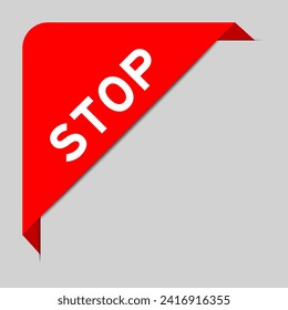 Red color of corner label banner with word stop on gray background