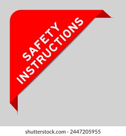 Red color of corner label banner with word safety instructions  on gray background