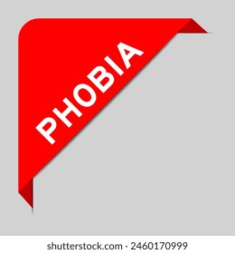 Red color of corner label banner with word phobia on gray background