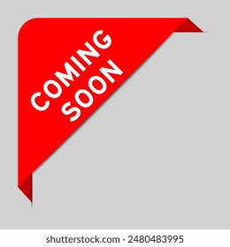 Red color of corner label banner with word coming soon on gray background