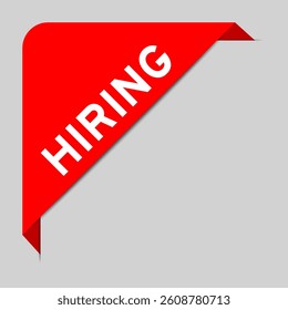 Red color of corner label banner with word hiring on gray background