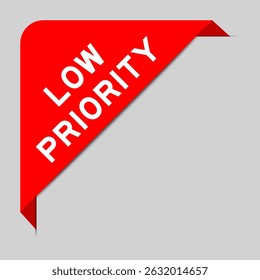 Red color of corner label banner with word low priority on gray background