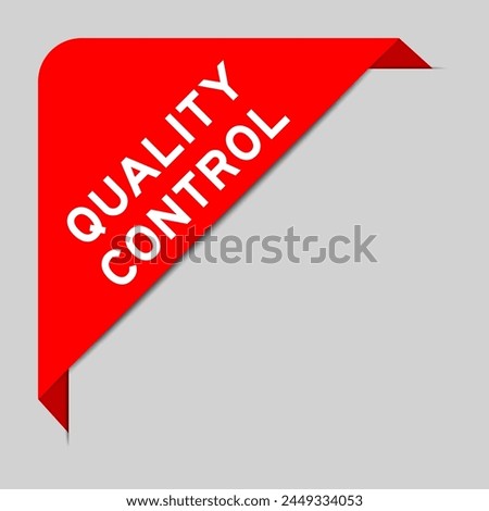 Red color of corner label banner with word quality control on gray background