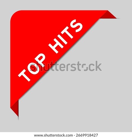 Red color of corner label banner with word top hits on gray background