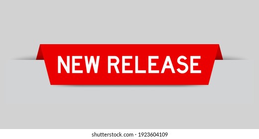 Red color inserted label with word new release on gray background