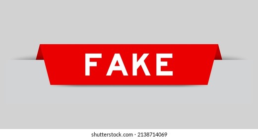 Red color inserted label with word fake on gray background