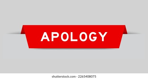 Red color inserted label with word apology on gray background