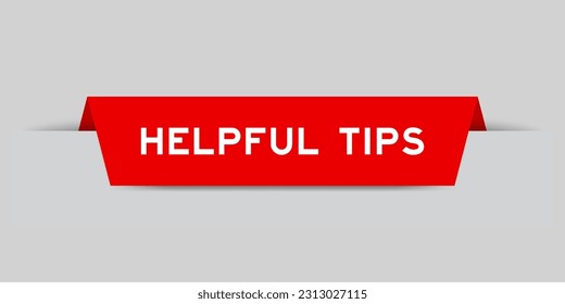 Red color inserted label with word helpful tips on gray background