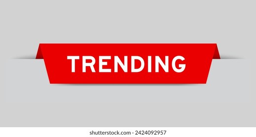 Red color inserted label with word trending on gray background