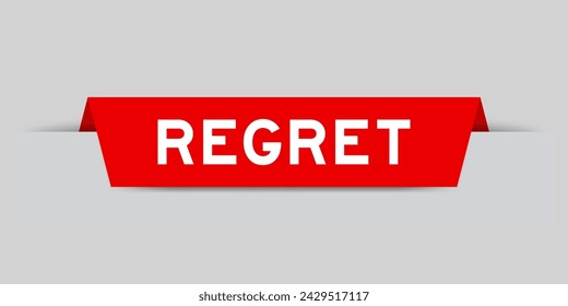 Red color inserted label with word regret on gray background