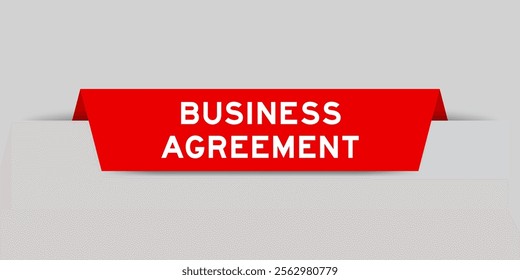 Red color inserted label with word business agreement on gray background