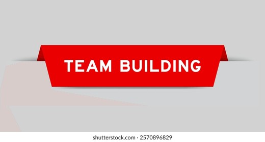 Red color inserted label with word team building on gray background