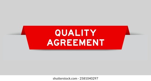 Red color inserted label with word quality agreement on gray background