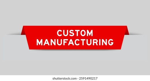 Red color inserted label with word custom manufacturing on gray background