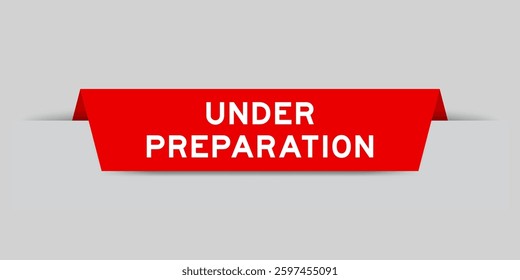 Red color inserted label with word under preparation on gray background