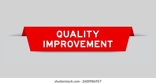 Red color inserted label with word quality improvement on gray background