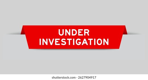 Red color inserted label with word under investigation on gray background