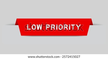 Red color inserted label with word low priority on gray background