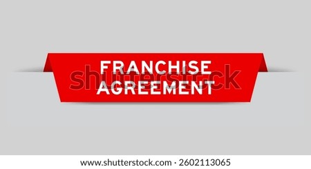 Red color inserted label with word franchise agreement on gray background