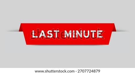 Red color inserted label with word last minute on gray background