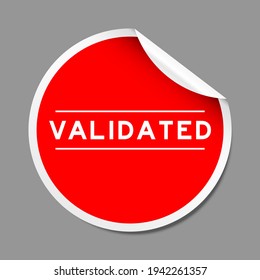 Red color peel sticker label with word validated on gray background