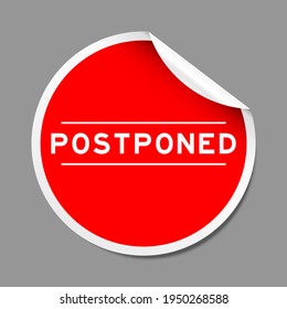 Red color peel sticker label with word postponed on gray background