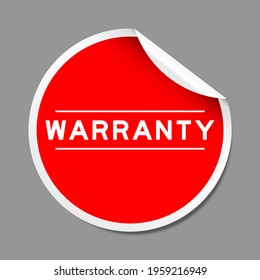 Red color peel sticker label with word warranty on gray background