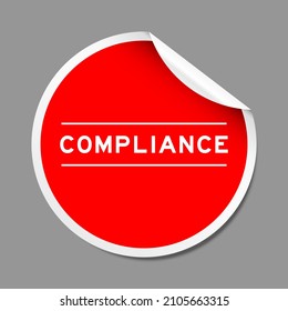 Red color peel sticker label with word compliance on gray background