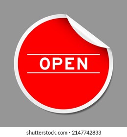 Red color peel sticker label with word open on gray background