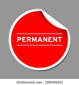 Red color peel sticker label with word permanent on gray background