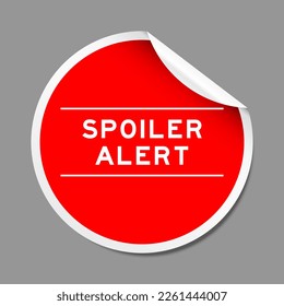 Red color peel sticker label with word spoiler alert on gray background