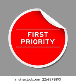 Red color peel sticker label with word first priority on gray background