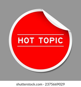 Red color peel sticker label with word hot topic on gray background