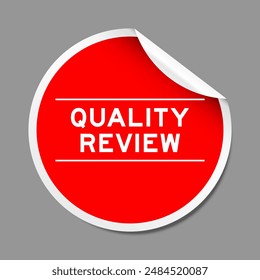 Red color peel sticker label with word quality review on gray background