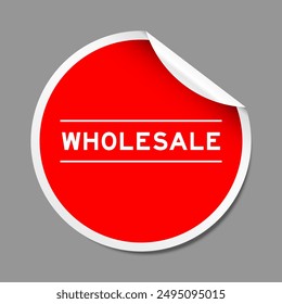 Red color peel sticker label with word wholesale on gray background