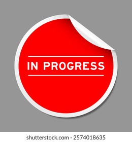 Red color peel sticker label with word in progress on gray background