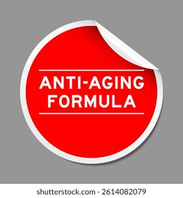Red color peel sticker label with word anti-aging formula on gray background