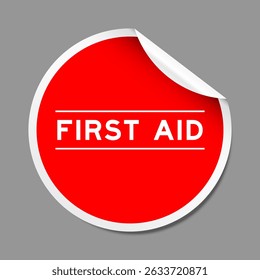 Red color peel sticker label with word first aid on gray background