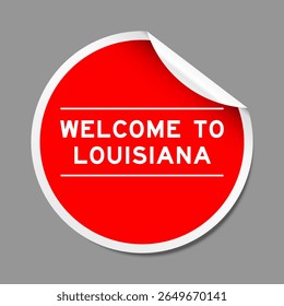 Red color peel sticker label with word welcome to louisiana on gray background