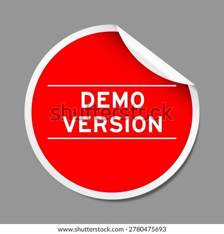 Red color peel sticker label with word demo version on gray background