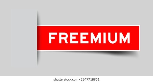 Red color square label sticker with word freemium that inserted in gray background